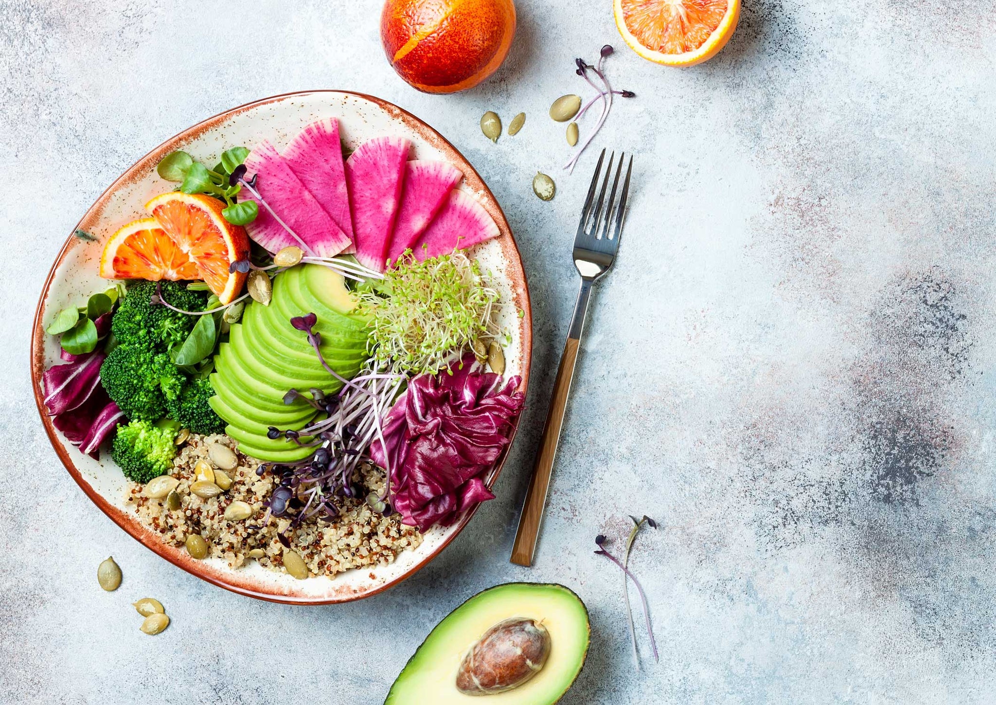 bowl of quinoa, avocado, fruits and vegetables